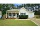 Charming single-story home with a well-manicured lawn, cozy front porch with rocking chairs, and attached one car garage at 3709 Fan Palm Ct, Raleigh, NC 27616