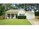 Charming single-story home with a well-manicured lawn, cozy front porch with rocking chairs, and attached one car garage at 3709 Fan Palm Ct, Raleigh, NC 27616