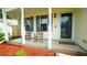 Inviting covered front porch with charming rocking chairs, decorative red mulch, and plenty of natural light at 3709 Fan Palm Ct, Raleigh, NC 27616