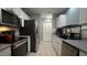 Functional kitchen featuring modern appliances, white cabinetry and tile floor at 3709 Fan Palm Ct, Raleigh, NC 27616