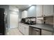 Well-organized kitchen with white cabinets, stainless steel appliances and tile flooring at 3709 Fan Palm Ct, Raleigh, NC 27616