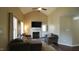 Comfortable living room features a fireplace, neutral decor, ample natural light and an exterior door at 3709 Fan Palm Ct, Raleigh, NC 27616