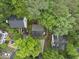 A serene aerial shot showcases a house nestled among verdant trees and manicured yards at 4 Weathergreen Ct, Durham, NC 27713