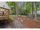 Scenic backyard featuring a rock-lined creek and mature trees at 4 Weathergreen Ct, Durham, NC 27713