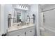 Well-lit bathroom featuring a double sink vanity and a shower-tub combination at 4 Weathergreen Ct, Durham, NC 27713