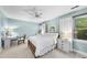 Bright bedroom featuring a ceiling fan, desk and ample natural light through a large window at 4 Weathergreen Ct, Durham, NC 27713