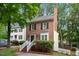 Charming two-story brick home with white trim and lush green landscaping at 4 Weathergreen Ct, Durham, NC 27713