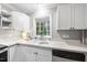 Kitchen area with stainless appliances, white cabinetry, and a bay window at 4 Weathergreen Ct, Durham, NC 27713