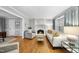 Bright living room with hardwood floors, a fireplace, and comfortable seating at 4 Weathergreen Ct, Durham, NC 27713