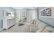 Cozy sitting room with a comfortable couch, chair, and bright natural lighting at 4 Weathergreen Ct, Durham, NC 27713