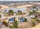 Aerial view of homes nestled around a pond with a golf course and lush landscaping at 405 Challenge Rd, Raleigh, NC 27603
