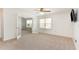 Bright bedroom features an attached office space, ceiling fan, neutral carpet, and ample natural light at 405 Challenge Rd, Raleigh, NC 27603