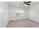 Cozy bedroom with neutral carpet, ceiling fan, and a large window with natural light at 405 Challenge Rd, Raleigh, NC 27603