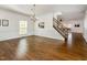 Spacious dining room with hardwood floors, wainscoting, and a chandelier at 405 Challenge Rd, Raleigh, NC 27603