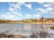 Scenic view of a golf course and lake with a beautiful clubhouse in the background at 405 Challenge Rd, Raleigh, NC 27603