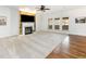 Cozy living room with a fireplace, built-in shelving, and hardwood floors at 405 Challenge Rd, Raleigh, NC 27603