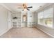 Home office features built-in shelving, neutral carpet, large window, and light grey walls at 405 Challenge Rd, Raleigh, NC 27603
