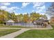 Community pool area featuring a spacious swimming pool, lounging areas, and mature trees at 405 Challenge Rd, Raleigh, NC 27603