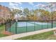 Outdoor tennis courts surrounded by trees and a black fence on a sunny day at 405 Challenge Rd, Raleigh, NC 27603