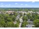 An aerial view of a charming town featuring tree-lined streets and historic architecture under a bright sky at 406 E Lee St, Smithfield, NC 27577