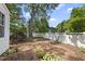 This brick backyard patio is surrounded by a white fence at 406 E Lee St, Smithfield, NC 27577