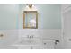 Traditional bathroom features a pedestal sink, gold fixtures, and classic white tile at 406 E Lee St, Smithfield, NC 27577