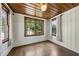 Cozy bedroom with wood-paneled ceiling, hardwood floors, and charming windows at 406 E Lee St, Smithfield, NC 27577