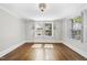 Bright bedroom with large windows, sconces, hardwood floors, and white trim at 406 E Lee St, Smithfield, NC 27577