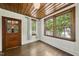 Cozy bedroom featuring wood paneling, hardwood floors, and ample natural light from multiple windows at 406 E Lee St, Smithfield, NC 27577