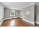 Bedroom with hardwood floors, neutral paint color, and natural light from large windows at 406 E Lee St, Smithfield, NC 27577