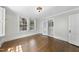 Bright bedroom features hardwood floors, natural light from windows, and access to an ensuite bathroom at 406 E Lee St, Smithfield, NC 27577