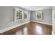 Bedroom with hardwood floors, neutral paint color, and natural light from large windows at 406 E Lee St, Smithfield, NC 27577