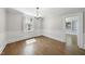 Bright dining room featuring hardwood floors, a classic chandelier, and an adjacent room at 406 E Lee St, Smithfield, NC 27577