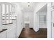 Bright foyer featuring hardwood floors, white wainscoting, and a staircase with white banisters at 406 E Lee St, Smithfield, NC 27577