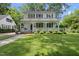 Charming two-story home featuring a welcoming front porch, lush lawn, and mature trees offering curb appeal at 406 E Lee St, Smithfield, NC 27577