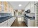 Well-lit kitchen showcasing white cabinets, a stainless steel stove, and access to a light-filled dining area at 406 E Lee St, Smithfield, NC 27577
