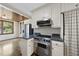 Kitchen featuring a stainless steel range, custom cabinetry, and adjoining dining area at 406 E Lee St, Smithfield, NC 27577