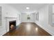 Bright, minimalist living room with hardwood floors, fireplace, and natural light creates a cozy ambiance at 406 E Lee St, Smithfield, NC 27577
