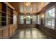Cozy living room featuring wood paneling, hardwood floors, built-in shelves, and ample natural light at 406 E Lee St, Smithfield, NC 27577