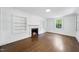 Bright living room with fireplace, built-in shelving, hardwood floors and natural light from the window at 406 E Lee St, Smithfield, NC 27577