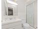Bright bathroom with a white tiled shower and glass door at 411 W Killiegrey St, Lillington, NC 27546