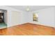Bright bedroom with hardwood floors, a closet, and a large window at 411 W Killiegrey St, Lillington, NC 27546