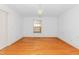 Sunlit bedroom featuring hardwood floors, neutral walls, and a charming window at 411 W Killiegrey St, Lillington, NC 27546