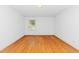 Light-filled bedroom with hardwood floors and a large window at 411 W Killiegrey St, Lillington, NC 27546
