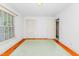 Bedroom with light green carpet, large window, and white closet doors at 411 W Killiegrey St, Lillington, NC 27546
