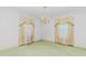 Formal dining room with chandelier, detailed molding, and vintage carpet at 411 W Killiegrey St, Lillington, NC 27546