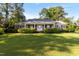 Charming single-story brick home with manicured front yard, covered porch, and mature landscaping at 411 W Killiegrey St, Lillington, NC 27546