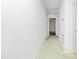 Long hallway with green carpet and doors leading to other rooms at 411 W Killiegrey St, Lillington, NC 27546