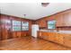 Traditional kitchen featuring wood paneling, white appliances, and ample counter space at 411 W Killiegrey St, Lillington, NC 27546