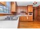 Close up kitchen featuring wood cabinets, hardwood floors, and stainless steel sink at 411 W Killiegrey St, Lillington, NC 27546